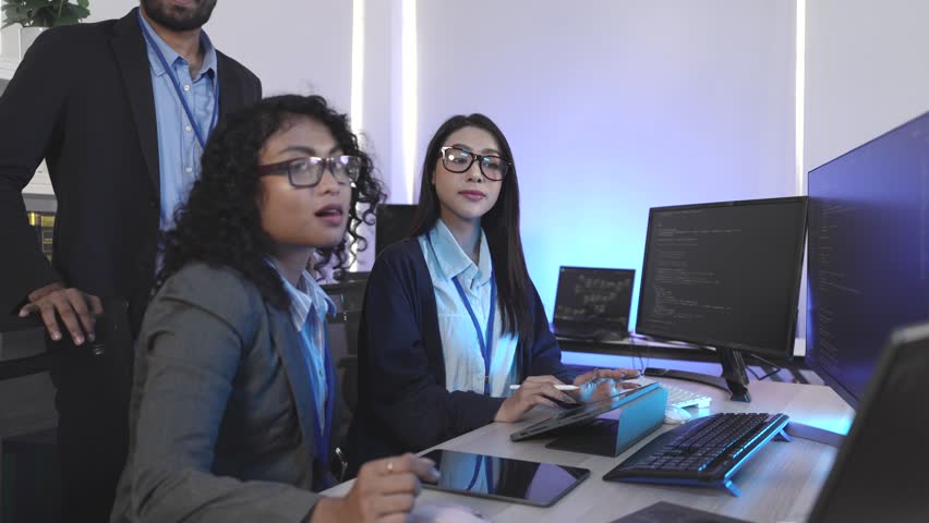 Expert IT team executing complex algorithm design and blockchain integration on multiple digital interfaces. Focused on decentralized solutions and neural network architecture in a cutting-edge develo