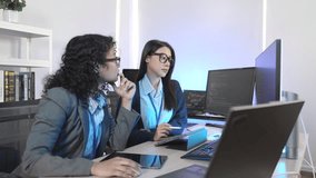 Diverse team of IT professionals collaborating on an AI project. A male manager mentors female colleagues in a modern office, analyzing data on a computer screen for digital transformation. - Powered by Shutterstock - Get 15% off with code: PIKWIZARD15