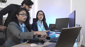 Forward-thinking tech team strategizing future innovations. Multi-ethnic professionals discuss AI-driven solutions in a bright, contemporary workspace, focused on a shared digital interface. - Powered by Shutterstock - Get 15% off with code: PIKWIZARD15