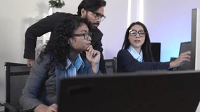 Diverse team of IT professionals collaborating on an AI project. A male manager mentors female colleagues in a modern office, analyzing data on a computer screen for digital transformation. - Powered by Shutterstock - Get 15% off with code: PIKWIZARD15