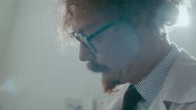 Psychiatrist explaining abstract charcoal drawing created by patient lying restrained on bed with blank expression during therapy session at mental hospital. Close-up shot - Powered by Shutterstock - Get 15% off with code: PIKWIZARD15