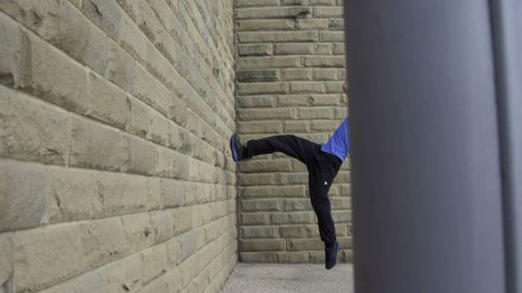 Backflip - Dolly: A free runner back flips off a wall in super slow motion