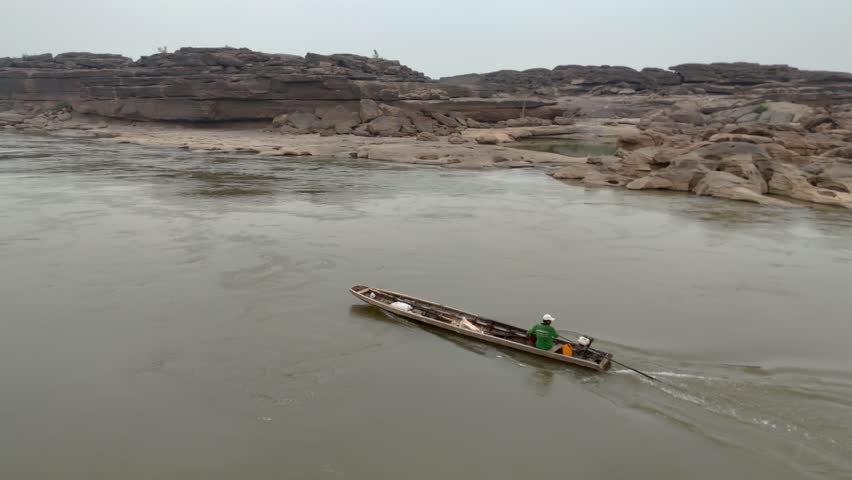 Fishermen are driving their boats on the Mekong River on the Thai border.