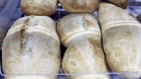 Fresh Ciabatta Bread on Bakery Display Shelf – Close-Up of Crusty Artisan Loaf in Warm Light – Rustic Bakery Scene with Freshly Baked Goods - Powered by Shutterstock - Get 15% off with code: PIKWIZARD15