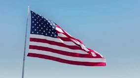 USA Flag Waving in the Wind Against Clear Sky - Powered by Shutterstock - Get 15% off with code: PIKWIZARD15