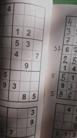 Vertical Slide shot reveals completed brain teaser number puzzle grid
