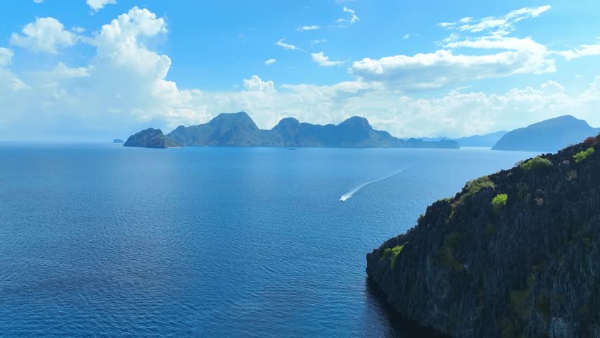 Aerial view of a beautiful tropical island with crystal clear water with limestone cliffs as the beach, Coron, Palawan, Philippines.	