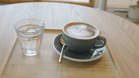 coffee latte art on wood table,A perfectly brewed cappuccino adorned with beautiful latte art, ideal for a morning treat or cafe indulgence. - Powered by Shutterstock - Get 15% off with code: PIKWIZARD15