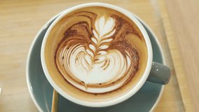 coffee latte art on wood table,A perfectly brewed cappuccino adorned with beautiful latte art, ideal for a morning treat or cafe indulgence. - Powered by Shutterstock - Get 15% off with code: PIKWIZARD15