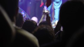 Recording a live music concert, people are capturing unforgettable moments with their smartphones in a vibrant venue, enhancing the energy and excitement of the performance - Powered by Shutterstock - Get 15% off with code: PIKWIZARD15
