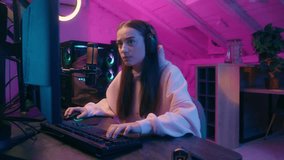Angry upset young woman girl female streamer gamer in headphones sitting at desk with keyboard computer monitor emotional playing online game loss shouting frustrated intense reaction in neon room - Powered by Shutterstock - Get 15% off with code: PIKWIZARD15