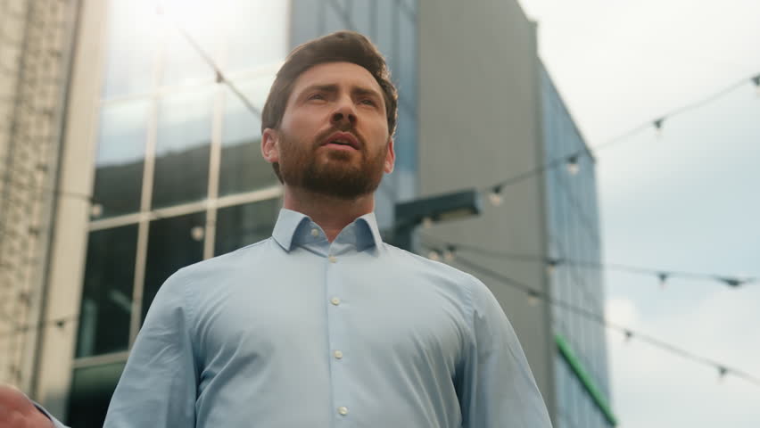 Middle-aged Caucasian business man holding jacket put on shoulder in city sunny businessman outside office smiling happy end of work day employer stylish entrepreneur male CEO in urban sunlight sun