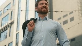 Middle-aged Caucasian business man holding jacket put on shoulder in city sunny businessman outside office smiling happy end of work day employer stylish entrepreneur male CEO in urban sunlight sun - Powered by Shutterstock - Get 15% off with code: PIKWIZARD15