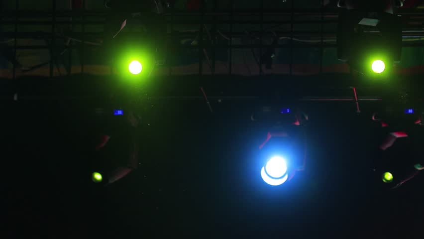 An empty stage of the theater, lit by spotlights and smoke before the performance