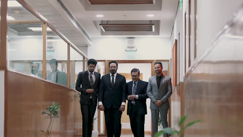 Indian senior businessman discussing with young managers or partners