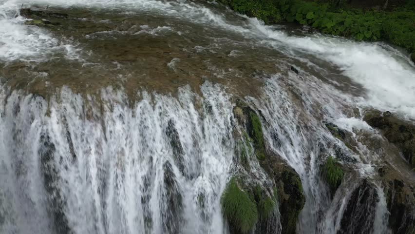 The spectacular waterfall at Marmore Falls, seen from a drone: the melted water from the glacier begins its journey toward the sea after the spring thaw.  drought aridity 