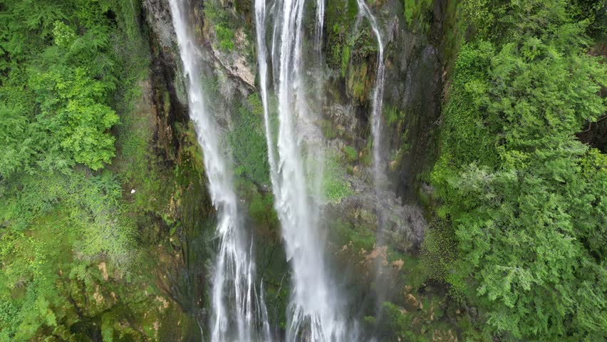 The spectacular waterfall at Marmore Falls, seen from a drone: the melted water from the glacier begins its journey toward the sea after the spring thaw.  drought aridity 