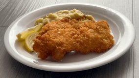 Pouring Gravy on a Plate of Pork schnitzel and Mashed Potatoes  - Powered by Shutterstock - Get 15% off with code: PIKWIZARD15