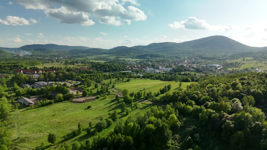 Charming Polish Village in Mountain Region with Country Road, Green Fields, and Blue Sky