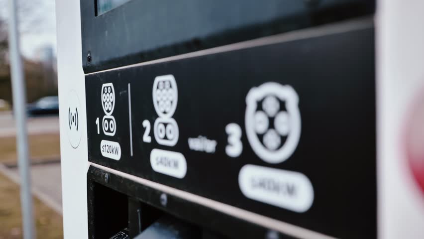 Camera slowly pulls away revealing EV charger details in subtle hand motion