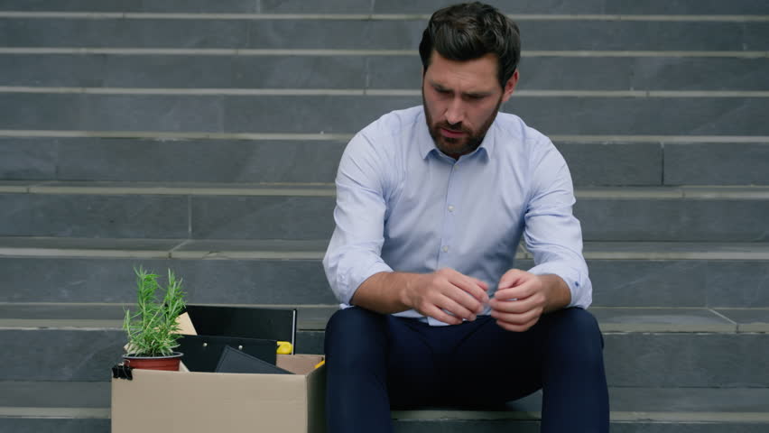 Middle-aged mature stressed anxious businessman lost job holding dismissal box suffering depress business man male in city outside office dismissed unemployment economic crisis financial bankrupt
