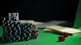 Stack of poker chips, red dice and money on green felt table, online casino play - Powered by Shutterstock - Get 15% off with code: PIKWIZARD15