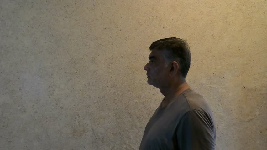Side Angle of Male Opening Mouth in Sudden Amazement at Unseen Object or Event in Tense Unexpected Moment