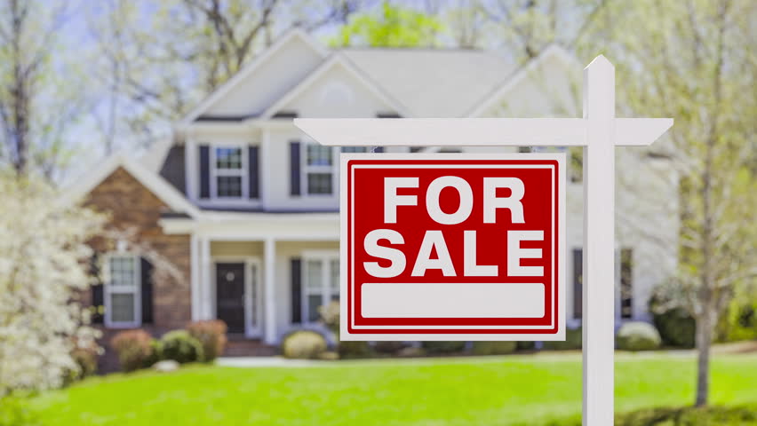 For Sale Real Estate Sign in Front of Beautiful House.