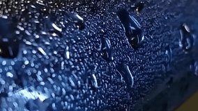 Wet surface with water droplets on it. The surface appears to be a metal object, possibly a car or a piece of machinery. The water droplets are scattered across the surface - Powered by Shutterstock - Get 15% off with code: PIKWIZARD15