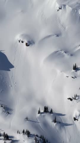 Aerial View Of Pristine Snowy Mountains In British Columbia, Canada During A Clear Winter Day