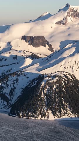 Stunning Aerial View of Snow-Covered Mountains and Frozen Lake in British Columbia, Canada