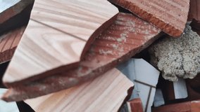 Heap of broken ceramic tiles and terracotta bricks, showcasing varied textures and colors, representing demolition or renovation waste materials. - Powered by Shutterstock - Get 15% off with code: PIKWIZARD15