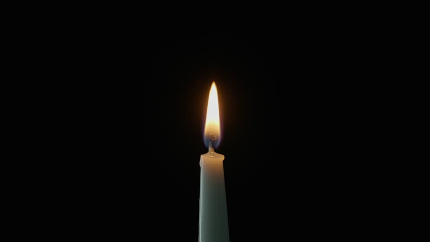 Lit wax taper standing alone against dark backdrop. Gentle flame moving on wind in quiet space. Single candle glowing steadily creating romantic setting on black. Thoughtful reflective mood concept