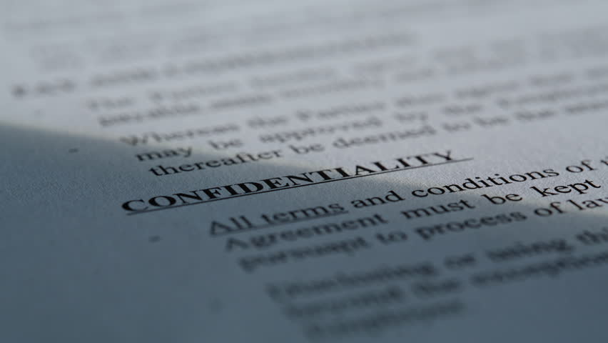 Closeup classified paper document with confidentiality text top secret. Macro shot information with security terms. Prohibition conditions on important private documentation. Corporate data concept 