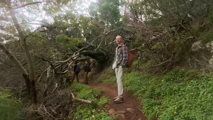 Three hikers, Two happy young children, boys 10-12 years old hiking on challenging, Family adventure, group trekking through dense, forest, Backpacking through wilderness, exploring nature
