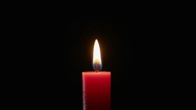 Breeze blowing out candle flame in darkness closeup. Wax taper fire dies against black backdrop. Night space glowing softly with flickering light. Calm reflective mood. Smoke going from wick to top - Powered by Shutterstock - Get 15% off with code: PIKWIZARD15