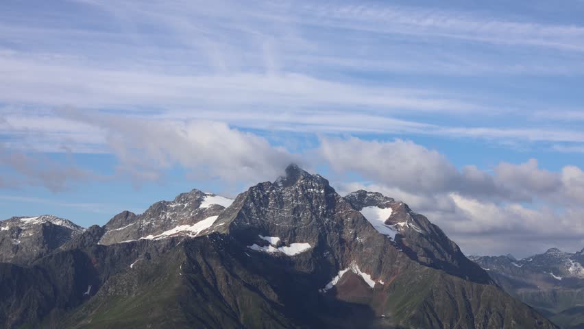 Alps mountains 4K timelapse of moving clouds. Lechtaler Alps in Austria video showing dramatic clouds moving over rugged mountain peaks, capturing the natural beauty and dynamic landscape of the Alps