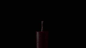 Hand lights paraffin candle using match on black background closeup. Bright flame and halo of fire around in dark room. Red wax taper inside studio. Concept of memory ritual celebration meditation - Powered by Shutterstock - Get 15% off with code: PIKWIZARD15