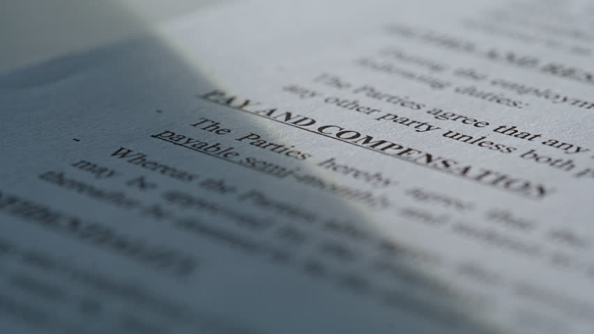 Detailed look at contract terms featuring private notice clearance. Enlarged angle shows protection rules pay and compensation conditions at sunny office closeup. Important business papers concept