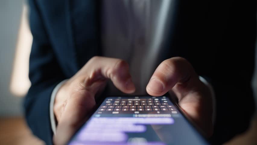 Man hands chatting smartphone online macro closeup. Unrecognizable businessman typing text message tapping touchscreen keyboard using messenger application in social media. User holding mobile phone