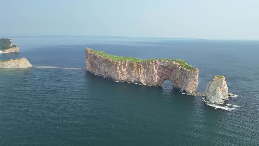 Aerial view orbiting around the Rocher Percé in Gaspésie