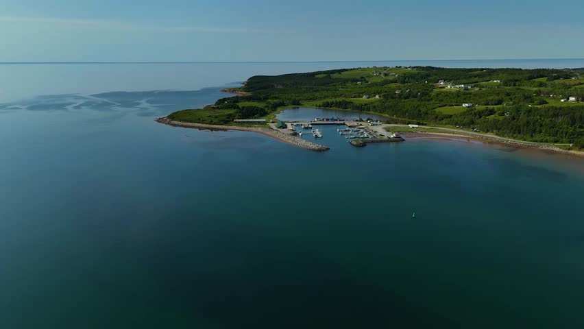 Panoramic aerial view of the west coast of Cape Breton in Nova Scotia.  Flying high, towards a lobster fishing harbour in a perfect weather.