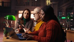 Focused students taking notes from academic library resources and reviewing archived materials in a study area, showing the dedication of mature education and knowledge building. Camera B. - Powered by Shutterstock - Get 15% off with code: PIKWIZARD15