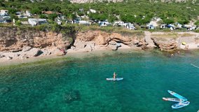 Beautiful Young Woman in Bikini Stand Up Paddling Sup Surfing in Stara Baska Skrila Beach Krk Island, Croatia. Mediterranean Summer. Aerial Shot From Above. Blue Sea the Rocks Mountains and Coastline - Powered by Shutterstock - Get 15% off with code: PIKWIZARD15