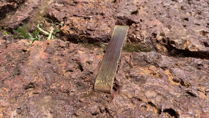 closeup of the metal link an old technology used in the binding two stone structure