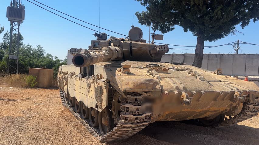 Merkava Mark 3 battle tank in action or on display. Israeli armored vehicle known for its heavy armor and desert capabilities. Captured in training or operational setting.
