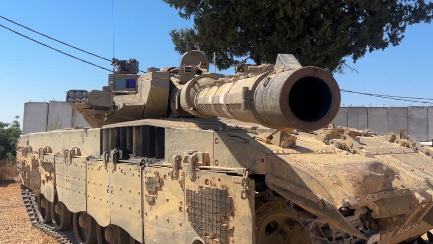Merkava Mark 3 battle tank in action or on display. Israeli armored vehicle known for its heavy armor and desert capabilities. Captured in training or operational setting.