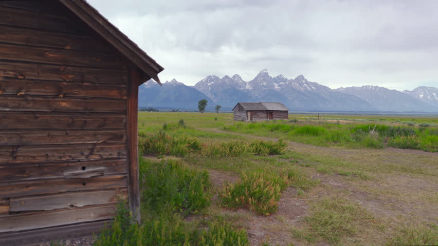 Immerse yourself in the incredible and serene beauty of John Moulton Barn as the sun rises majestically over Grand Teton National Park, situated at Mormon Row, a true showcase of natures splendor