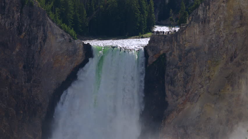 Experience the stunning beauty of the Lower Falls, where waterfalls cascade within the picturesque Grand Canyon of the Yellowstonea mustsee for nature lovers and adventure seekers