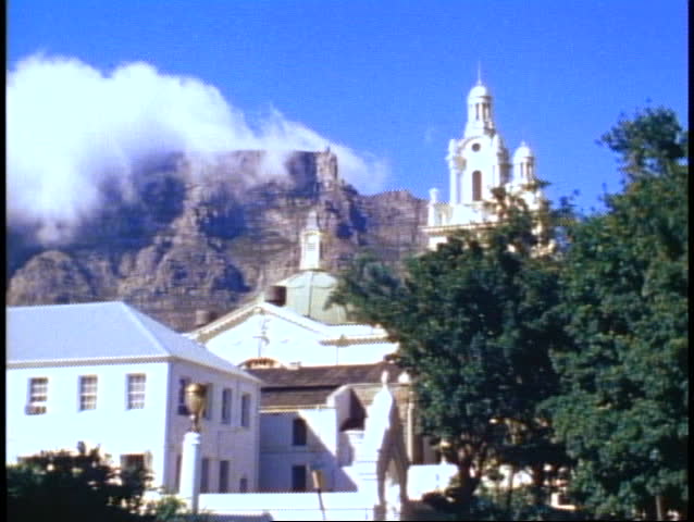 Table Mountain, clouds atop, medium shot, colonial buildings foreground